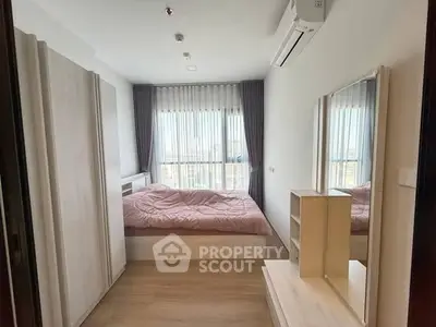 Cozy bedroom with modern decor and large window for natural light