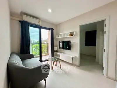 Modern living room with balcony view, sleek furniture, and natural light.