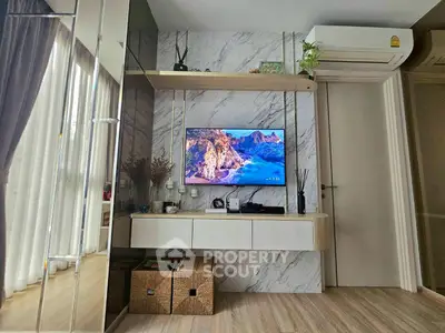 Modern living room with stylish decor and wall-mounted TV, featuring elegant marble accents and cozy atmosphere.
