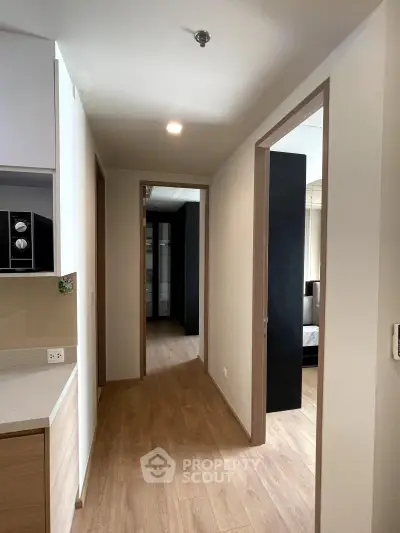 Modern apartment hallway with wooden flooring and sleek design