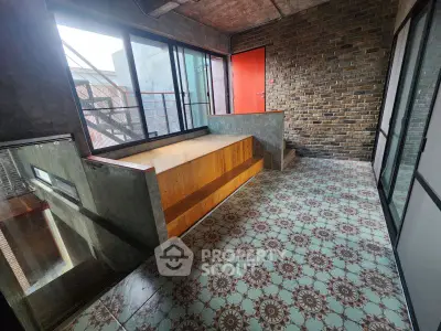 Stylish industrial loft with unique brick wall and patterned tile flooring