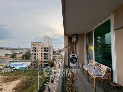 Spacious balcony with city view and cozy seating area in modern apartment