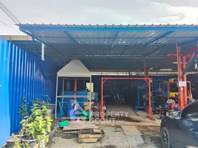 Industrial property with metal roofing and open workspace, ideal for workshops or storage solutions.