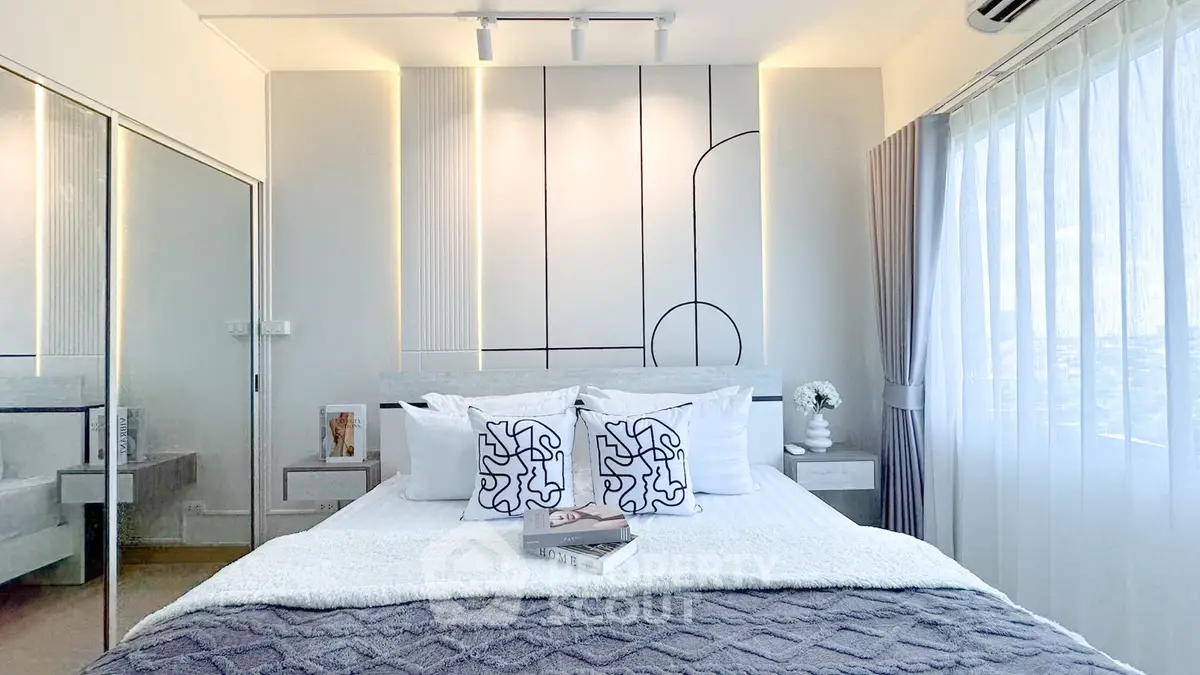 Modern bedroom with stylish decor and large window offering natural light