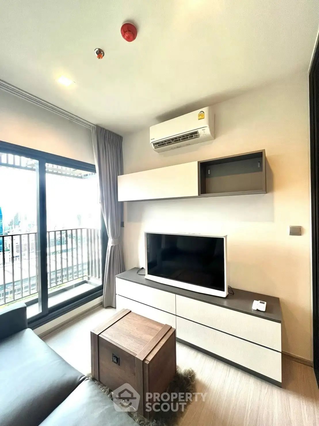 Modern living room with sleek furniture and balcony view