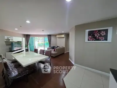 Spacious living room with dining area and modern decor in a stylish apartment.