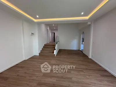 Spacious modern living room with elegant wooden flooring and recessed lighting
