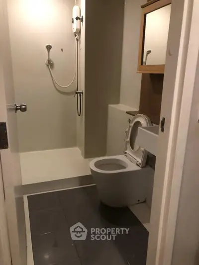 Compact bathroom with shower and toilet in modern apartment