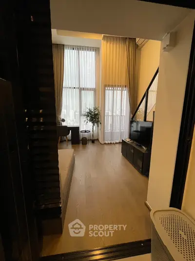 Modern living room with high ceilings and large windows in luxury apartment