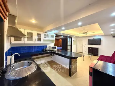 Spacious open-layout kitchen with modern appliances and stylish living area