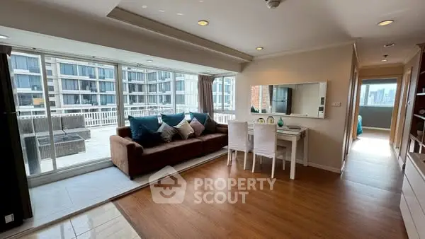 Spacious living room with large balcony and modern decor