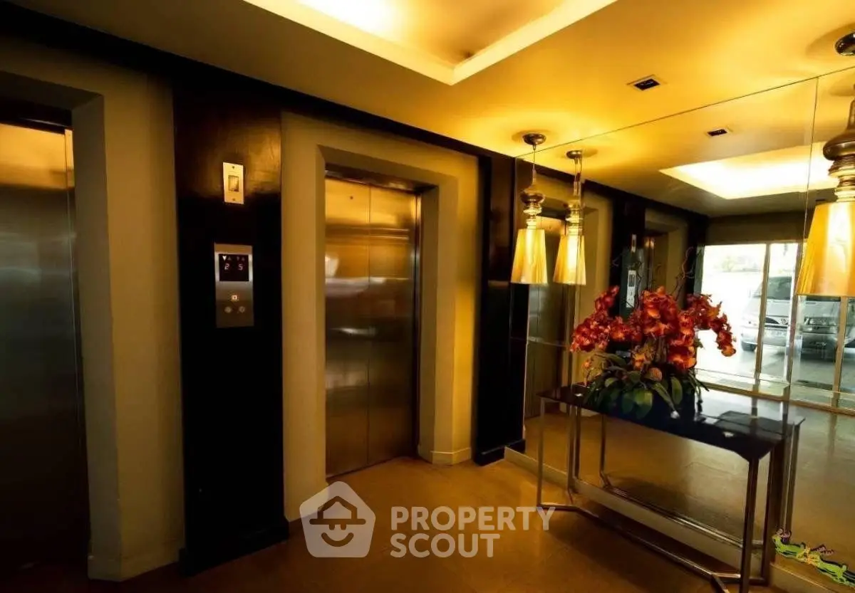Luxurious elevator lobby with elegant lighting and floral decor