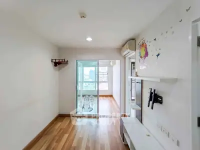 Spacious living room with wooden flooring and balcony access in modern apartment.
