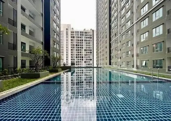 Luxurious apartment complex with stunning outdoor pool and modern architecture.