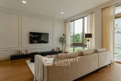 Spacious modern living room with large windows and elegant decor