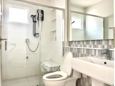 Modern bathroom with glass shower and sleek fixtures