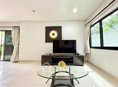 Spacious living room with modern decor and large windows for natural light.