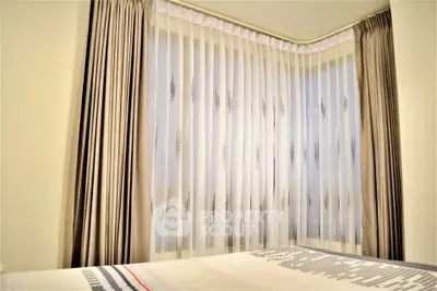 Cozy bedroom corner with elegant curtains and soft lighting