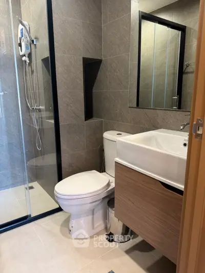 Modern bathroom with sleek fixtures and glass shower enclosure