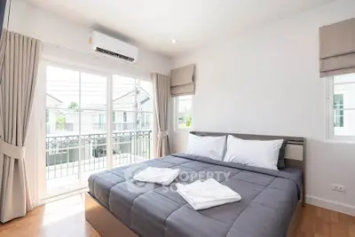 Bright and airy bedroom with balcony access in modern home