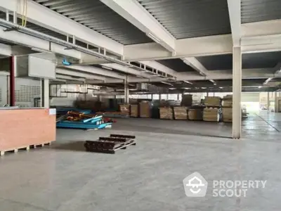 Expansive industrial warehouse space with high ceilings and ample storage capacity, ideal for large-scale operations and logistics.