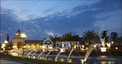 Luxurious estate with elegant fountains and palm trees at dusk