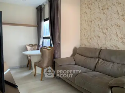 Cozy living room with elegant dining area and plush sofa in modern apartment.