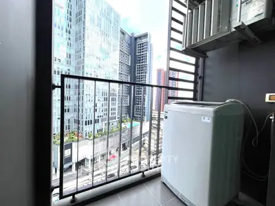 Modern balcony with city view and washing machine, perfect for urban living.