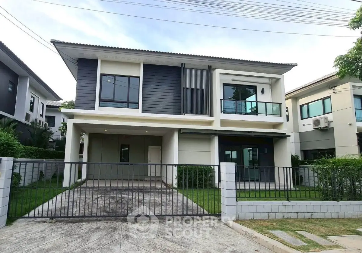 Modern two-story house with sleek design and spacious driveway in a serene neighborhood.