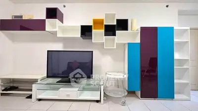 Modern living room with colorful shelving and sleek TV stand
