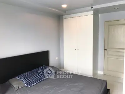 Modern bedroom with sleek design and built-in wardrobe in a stylish apartment.