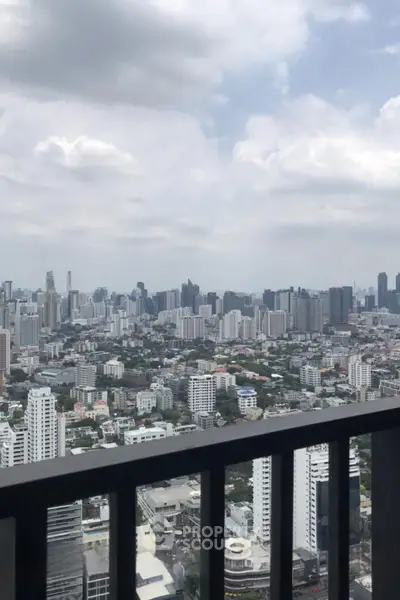Stunning cityscape view from a high-rise balcony showcasing urban skyline and architecture.