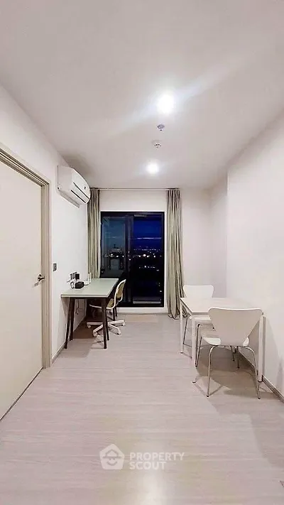 Modern study room with city view, featuring sleek furniture and ample natural light.