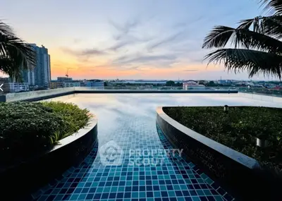 Stunning rooftop pool with panoramic city views at sunset, perfect for luxury living.