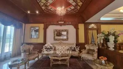 Luxurious living room with elegant furniture and chandelier in a classic style home.