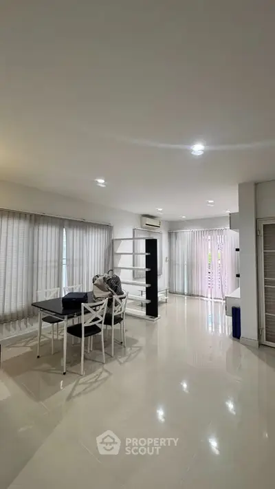 Spacious modern living room with elegant dining area and natural light