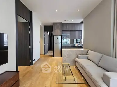Modern living room with sleek design, open kitchen, and stylish furniture in a contemporary apartment.