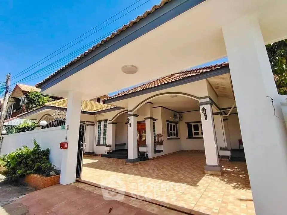 Charming single-story home with spacious carport and tiled patio in sunny neighborhood.