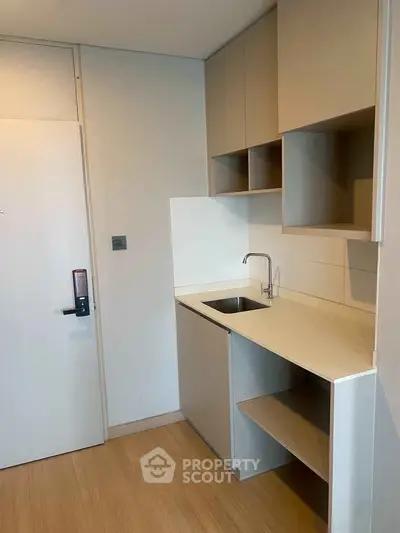 Modern compact kitchen with sleek cabinetry and minimalist design