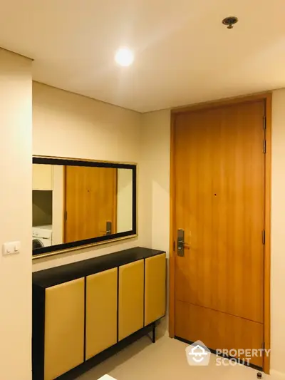 Modern apartment entrance with sleek wooden door and stylish console table