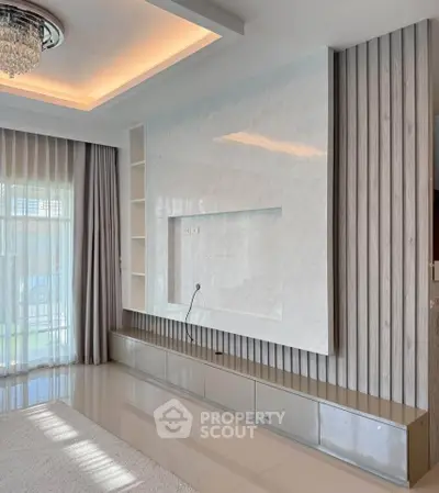 Modern living room with elegant ceiling design and large window drapes