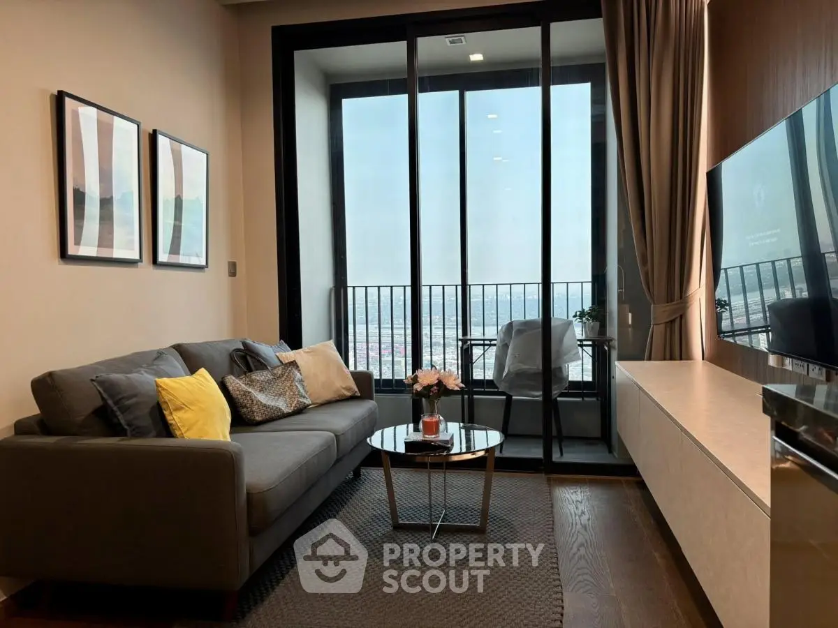 Modern living room with balcony view, stylish decor, and cozy seating area.