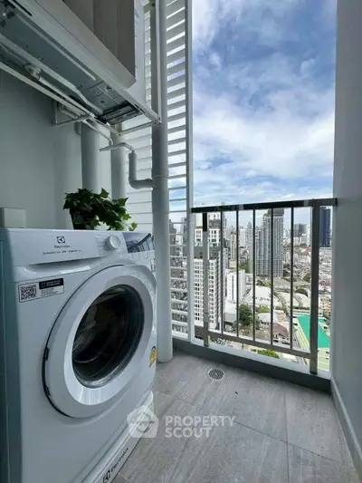 Modern high-rise balcony with washing machine and stunning city view.