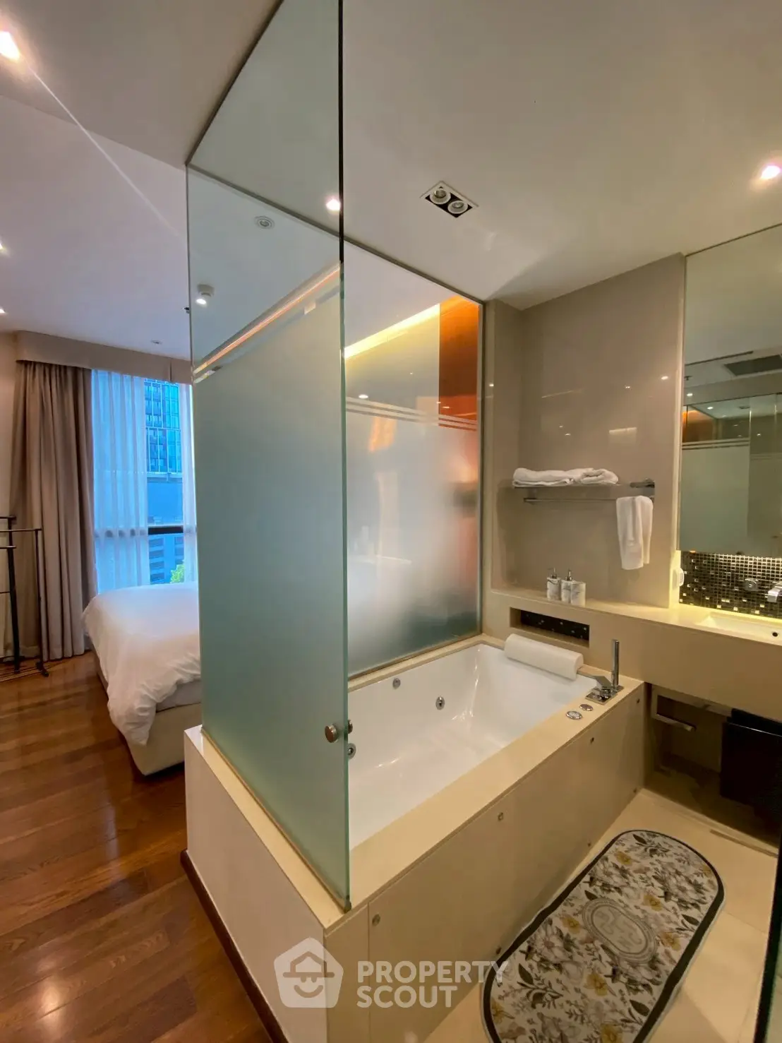Luxurious modern bathroom with frosted glass partition and elegant fixtures