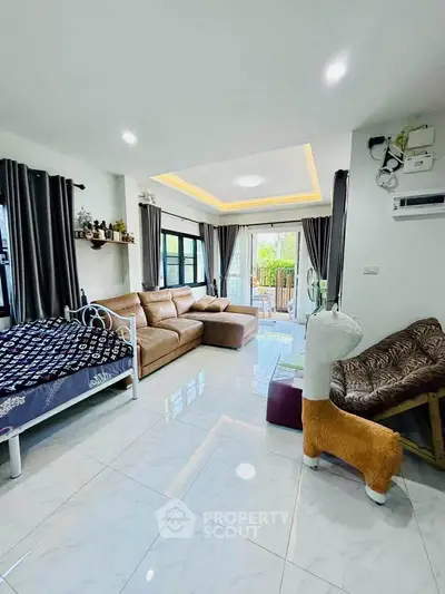 Spacious living room with modern decor and large windows for natural light.