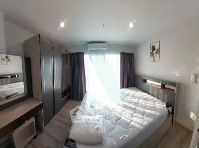 Modern bedroom with stylish furniture and natural light, featuring a comfortable bed and elegant decor.