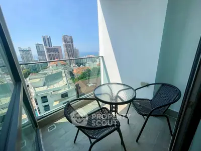 Chic urban balcony with stunning cityscape and ocean views, perfect for relaxation.