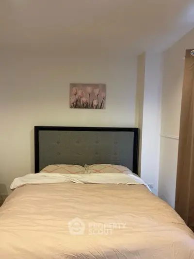 Cozy bedroom with elegant decor and plush bedding, perfect for relaxation.