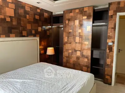 Luxurious bedroom with unique geometric wall design and spacious closet