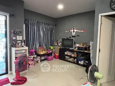 Cozy living room with modern decor and ample storage space, perfect for family gatherings.
